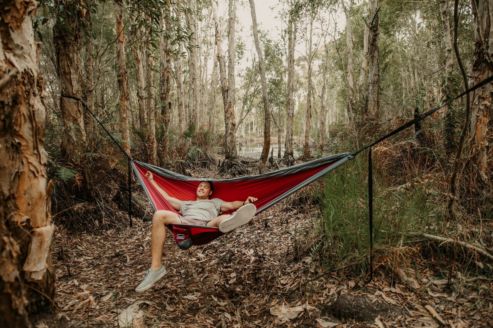 woman in red shirt lying on hammock